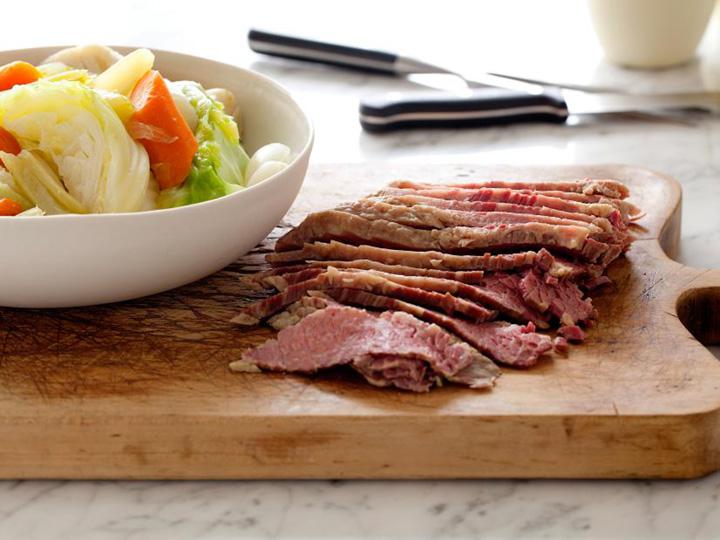 Corned beef and cabbage on wooden cutting board