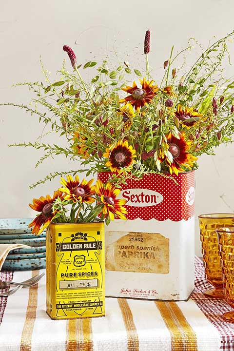 Recycle your old tin cans to use as vintage flower holder center pieces