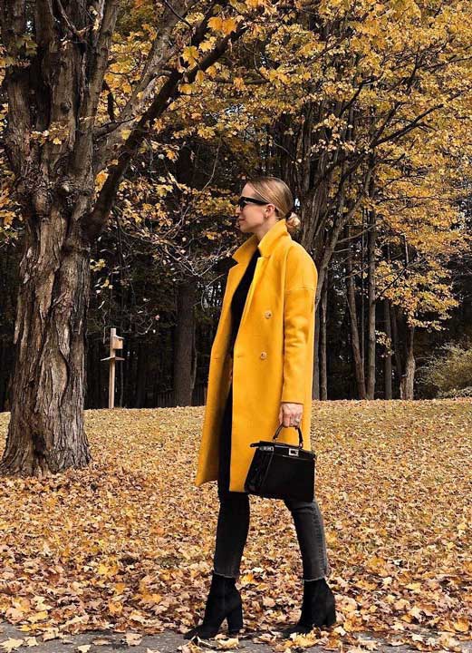 this yellow accent coat is striking against the darker earth tones seen in the fall.