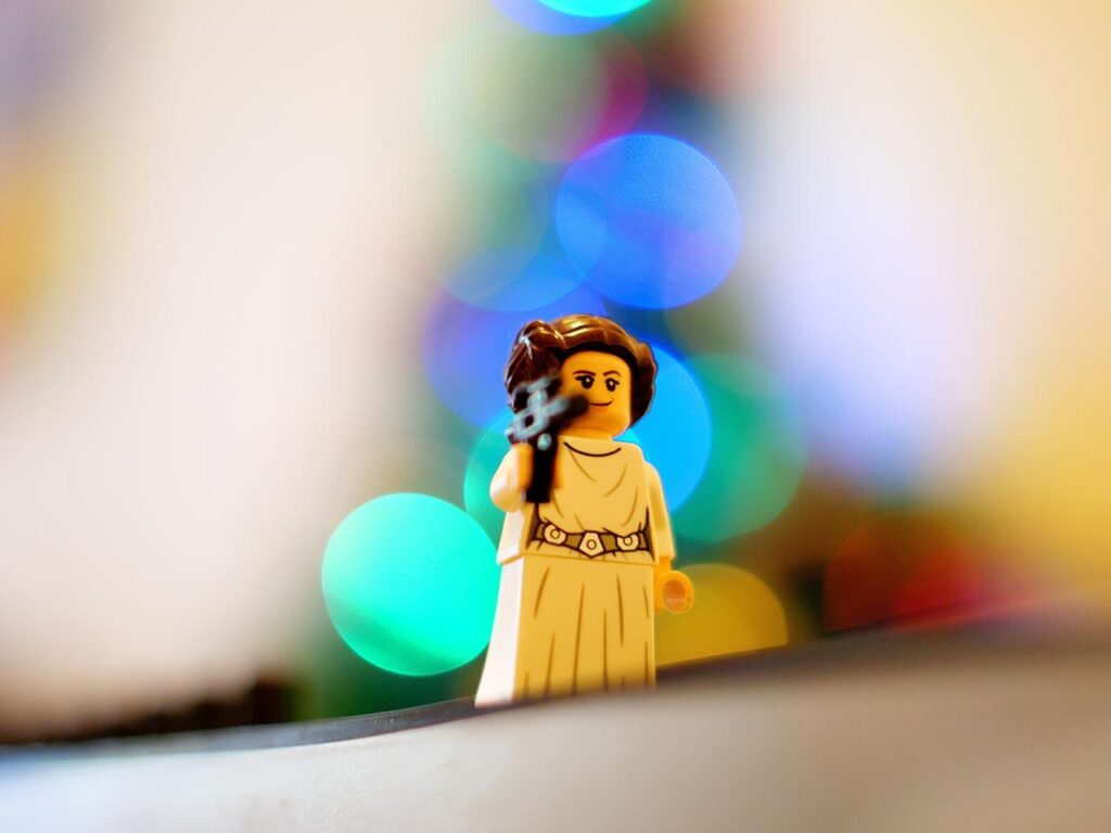 A Lego Princess Leia holds a blaster